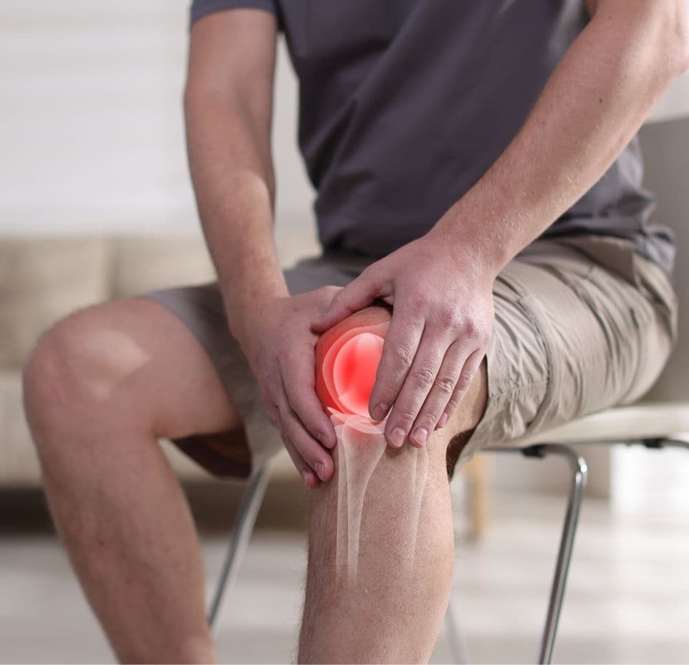 Ilustracja ludzkiej sylwetki z zaznaczonymi czerwonymi punktami zapalnymi na kręgosłupie i stawach, symbolizująca rozproszony ból przewlekły.